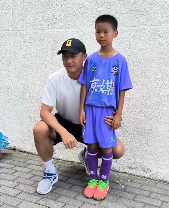京媒：傅明现身百队杯现场，蹲下与小球员合影并交流经验